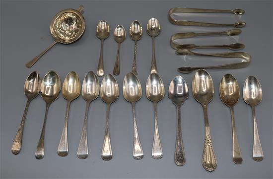 Small silver spoons, sugar tongs and a tea strainer